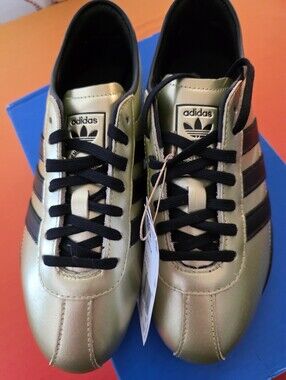 Adidas Womens Metallic Gold Sneakers with Black Stripes